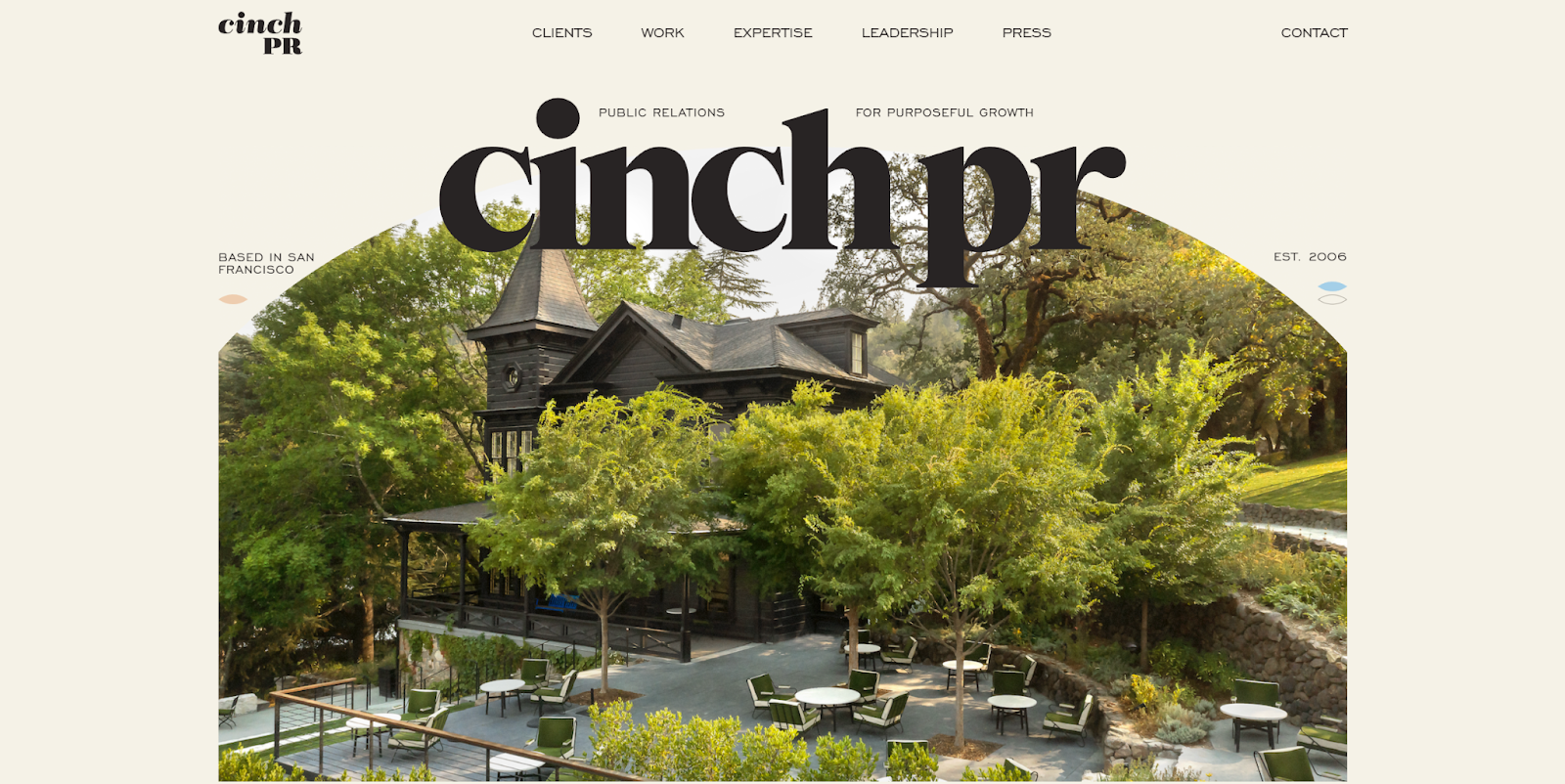The Cinch PR website homepage features an image of a resort in a forest.