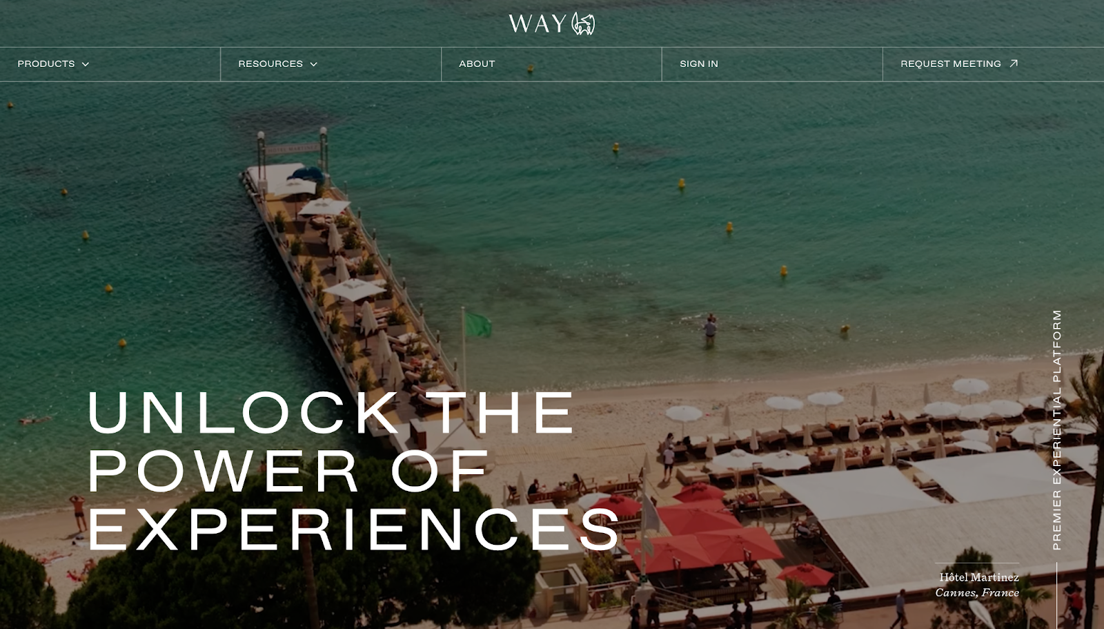 A screenshot of Way's website, showing a looping video of a waterfront deck restaurant with the text overlay, “Unlock the power of experiences.”